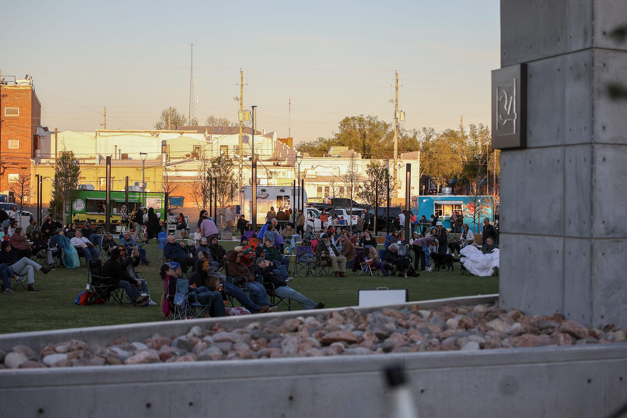 A crowd of attendees seated in lawn chairs on the grass at Block 34 in downtown Stillwater during the Block 34 Live season opener April 11.