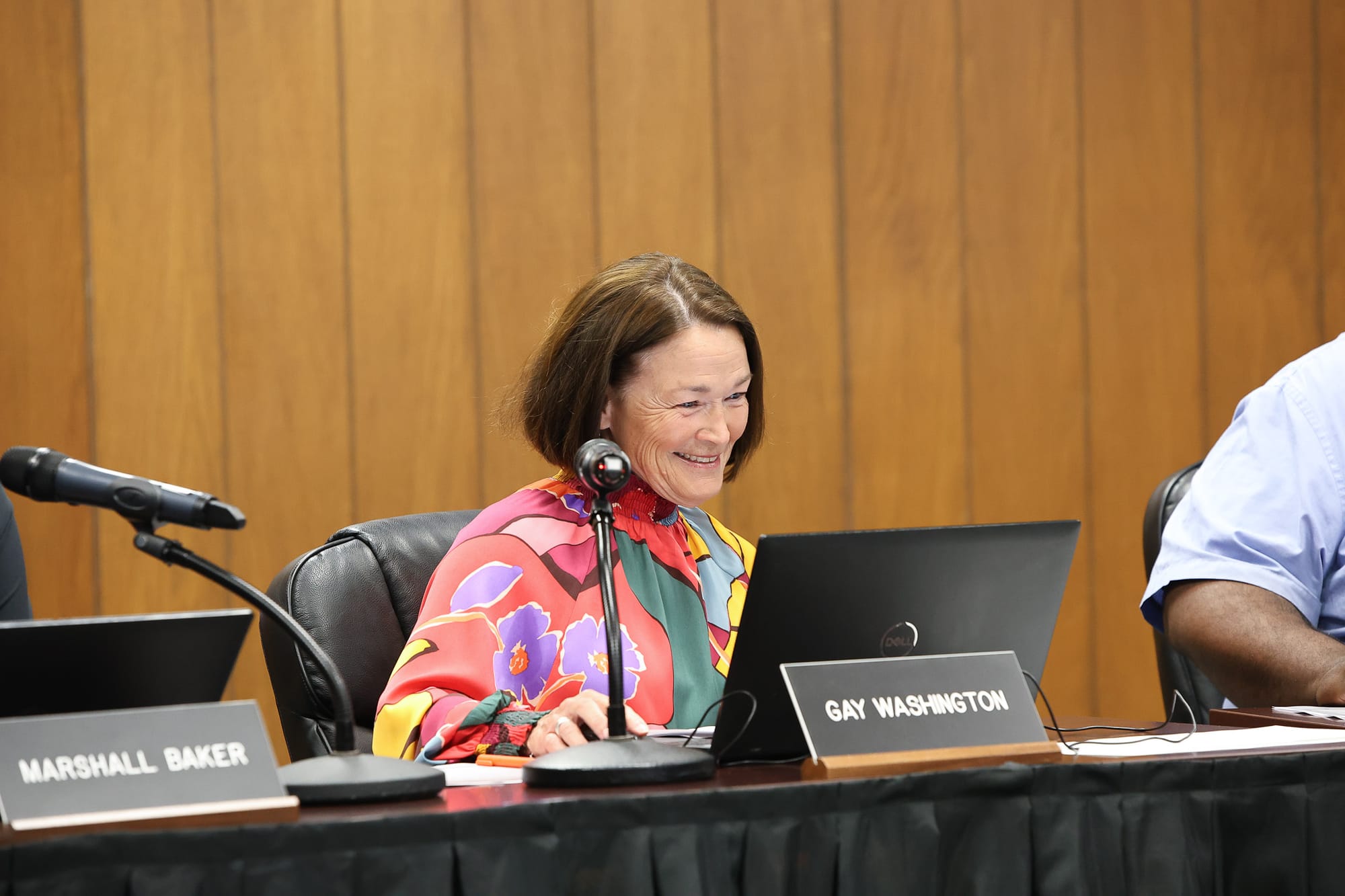 Dr. Gay Washington smiles while reviewing materials at the board table during the Stillwater Board of Education regular meeting April 14, 2026.