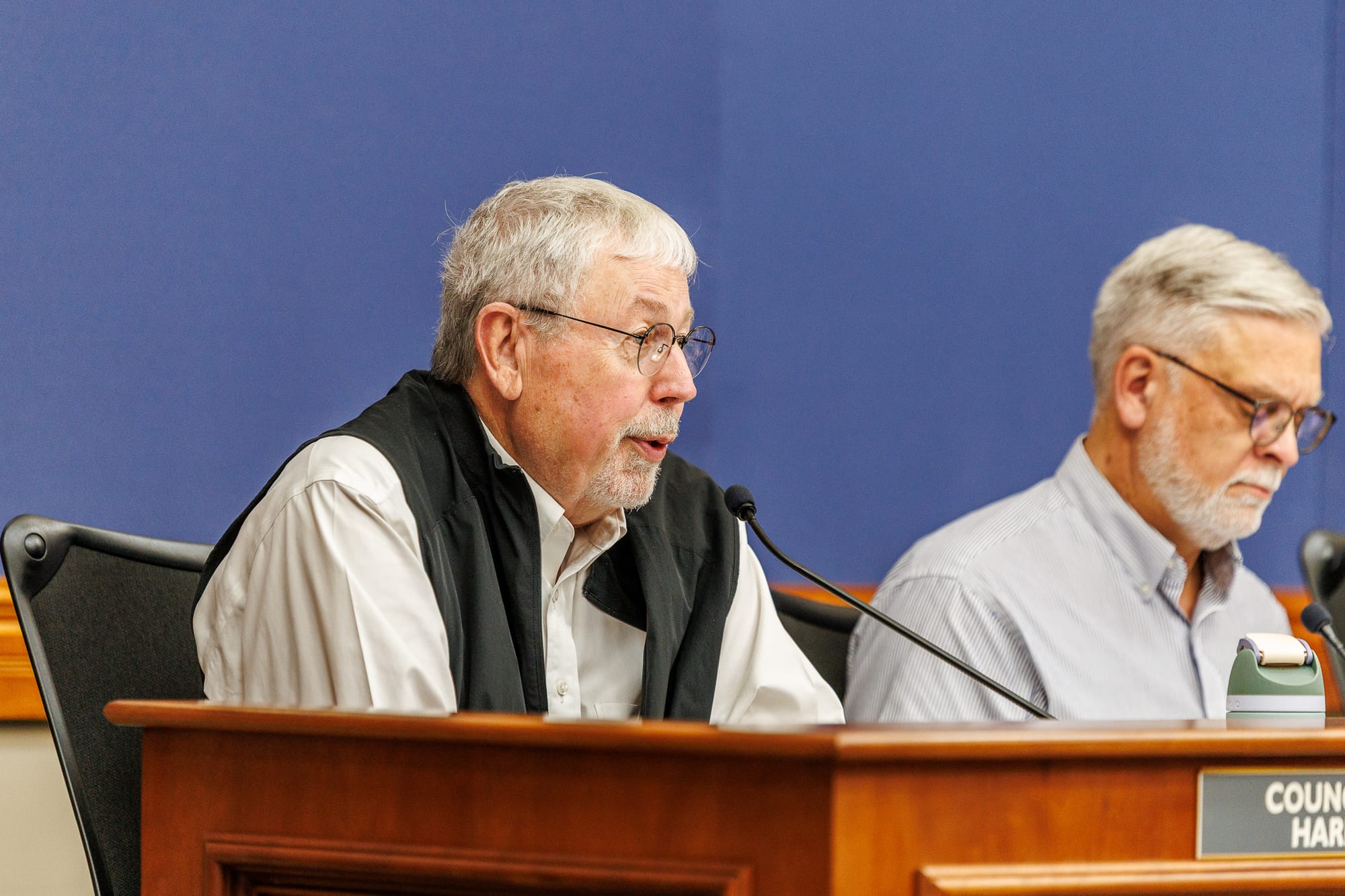 Stillwater City Councilor Tim Hardin speaks at the council dais during the May 18, 2026 meeting, with another council member visible in the background.
