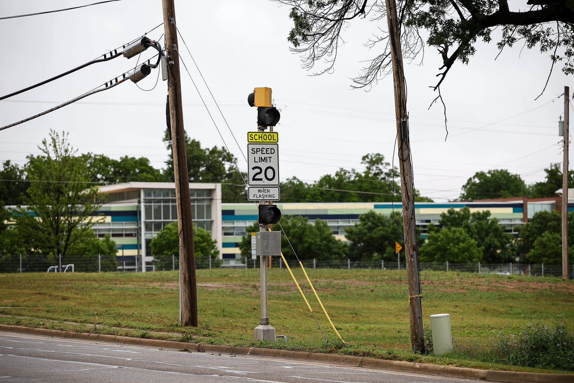 A school zone speed limit sign reading 20 mph when flashing stands in front of Will Rogers Elementary School on N. Washington St. in Stillwater.
