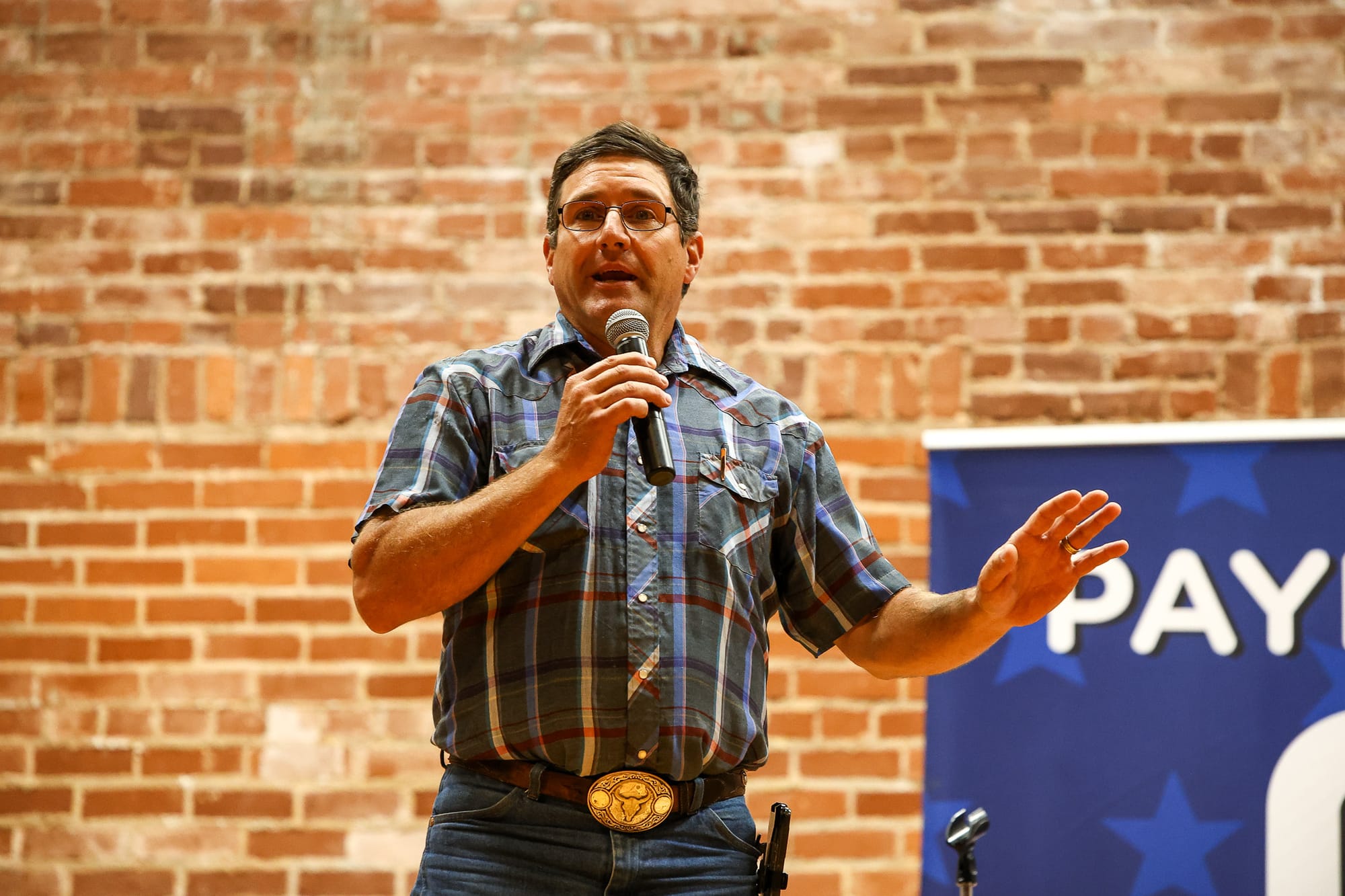 Commissioner Zach Cavett speaks into a microphone at the Payne County GOP candidate forum on June 11, 2026, at the Stillwater Community Center in Stillwater.