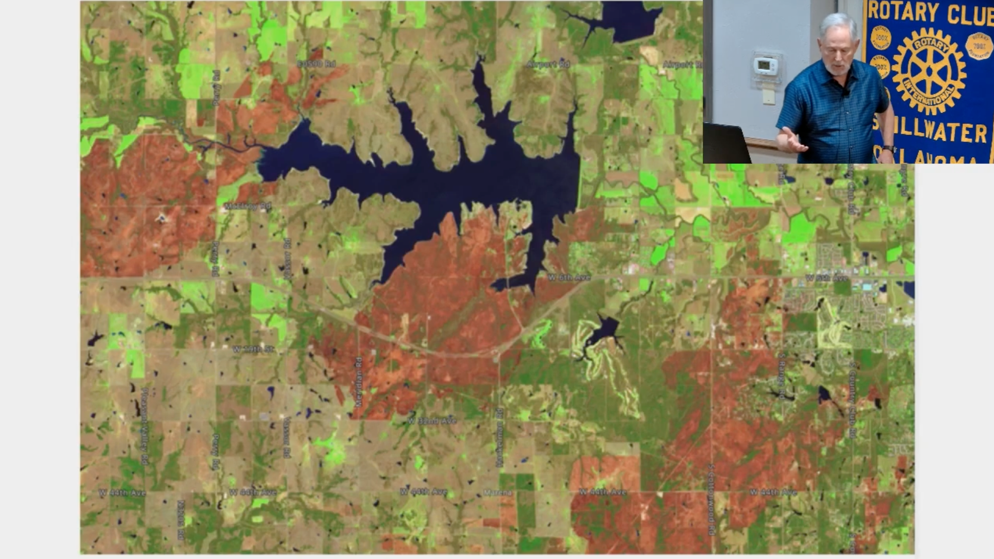 False-color satellite image showing the March 14, 2025 wildfire perimeter near Stillwater and Lake Carl Blackwell, with burned areas in red and unburned land in green.