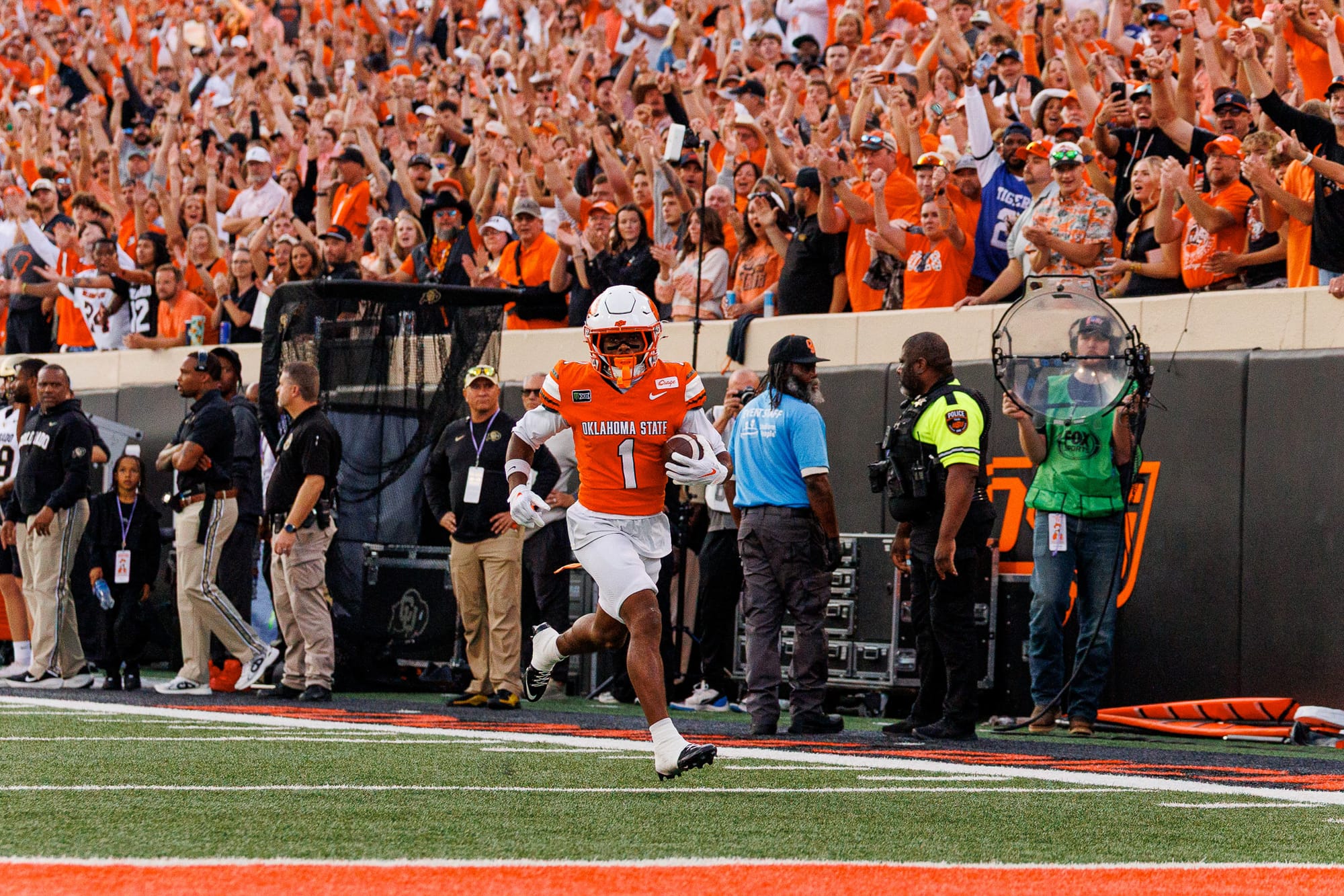 OSU wide receiver Miles Coleman runs toward the end zone on a 47-yard touchdown catch against Colorado on Oct. 24, 2026, at Boone Pickens Stadium as fans cheer behind him.