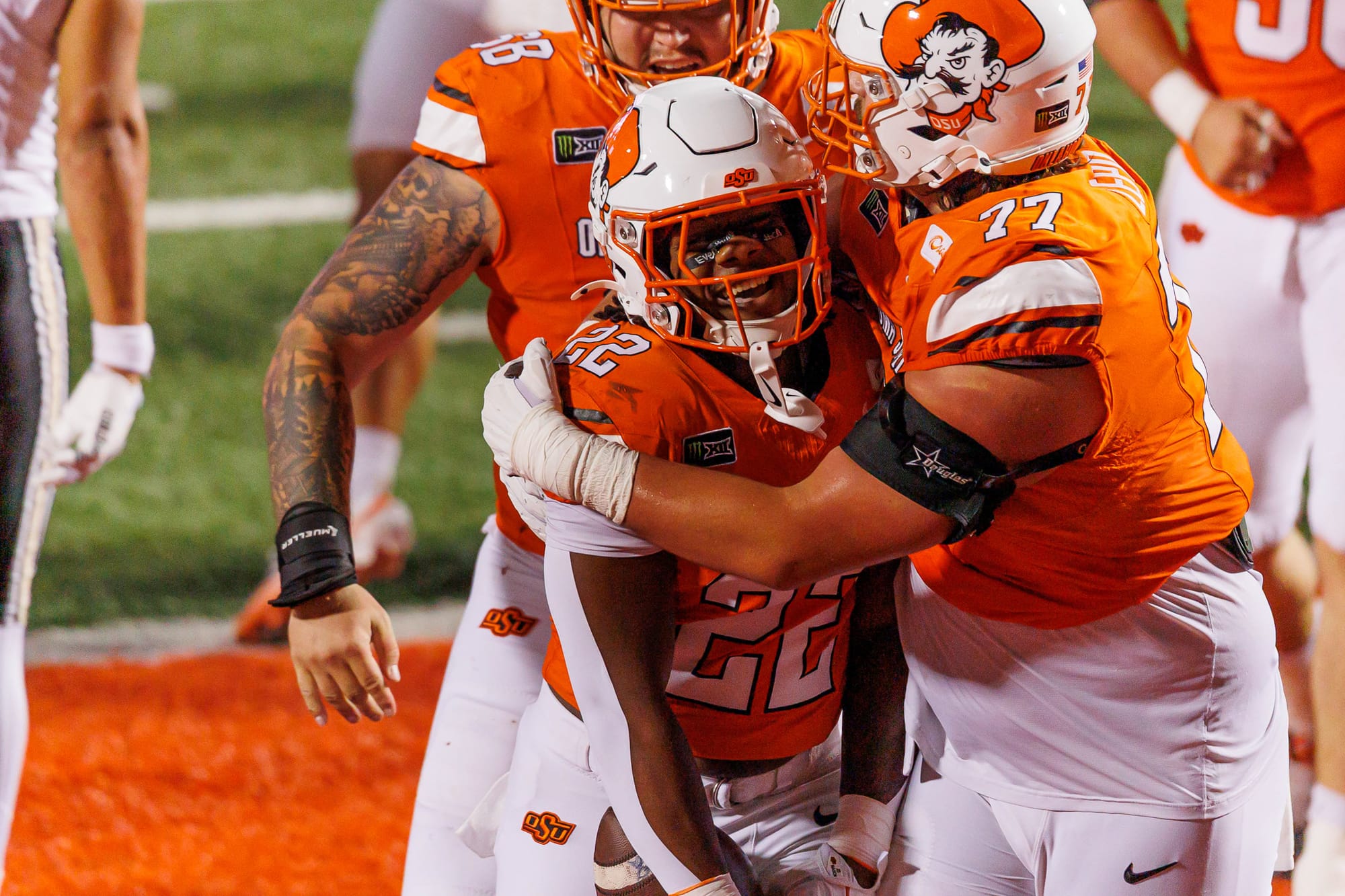 OSU running back William Mason smiles as offensive lineman Ashton Lepo hugs him after his touchdown run against Colorado on Oct. 24, 2026, at Boone Pickens Stadium.