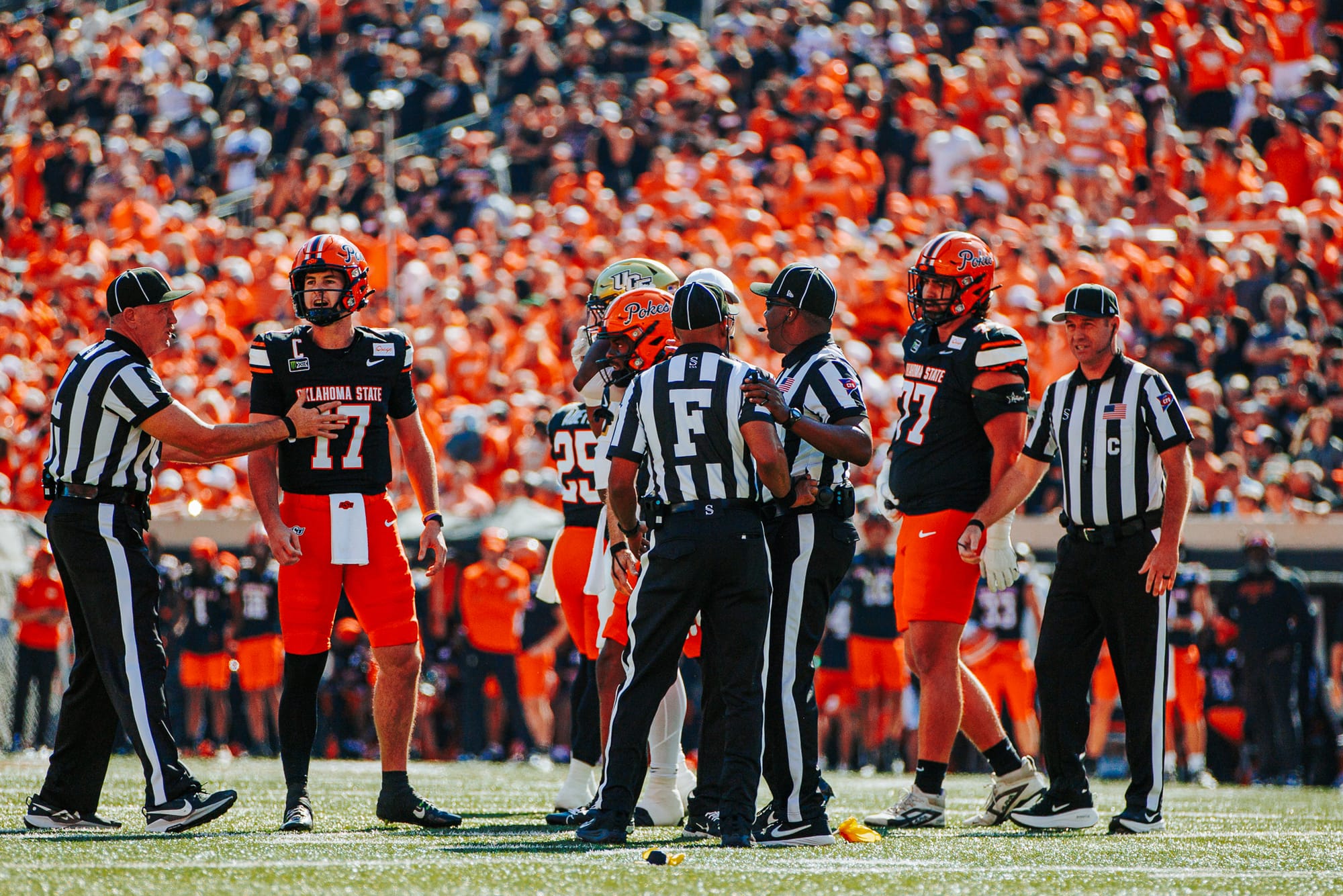 OSU quarterback Drew Mestemaker talks with an official as other officials separate players after a penalty against UCF on Oct. 10, 2026, at Boone Pickens Stadium.
