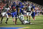 Stillwater running back Jaedan Adams (3) carries the ball near the goal line as Muskogee defender Dredyn Spencer (17) reaches for him from the turf at Pioneer Stadium, Oct. 22, 2026.
