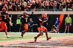 OSU safety Evan Jackson steps into the end zone holding the ball after a fumble return touchdown against UCF on Oct. 10, 2026, at Boone Pickens Stadium as teammates celebrate.