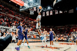 Christian Coleman in mid-air preparing to dunk during Oklahoma State's 84-83 win over Kansas State at Gallagher-Iba Arena on January 17, 2026