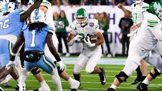 North Texas running back Caleb Hawkins carries football against Tulane defenders during American Athletic Conference Championship Game in New Orleans on Dec. 5, 2025.
