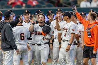 Oklahoma State center fielder Kollin Ritchie celebrates with teammates after home run against Vanderbilt at Globe Life Field.