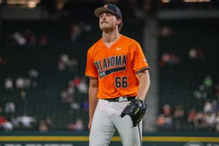Oklahoma State pitcher Mario Pesca in orange jersey walks off mound during game against Oklahoma at Globe Life Field in Arlington, Texas on February 14, 2026. 