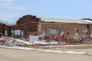 Exterior view of Washington School showing brick building with boarded windows as restoration work progresses on the historic all-Black school built in 1938 in Stillwater
