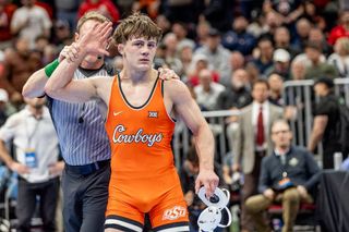 OSU's Landon Robideau has his hand raised after defeating top-seeded PJ Duke of Penn State in the 157-pound semifinals at the 2026 NCAA Wrestling Championships in Cleveland.
