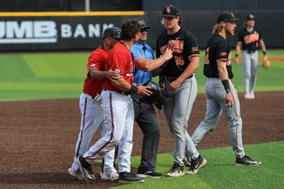 OSU pitcher Hudson Barrett confronts Texas Tech catcher Matt Quintanar at third base during the ninth inning of OSU's 9-8 win at Rip Griffin Park in Lubbock, Texas.