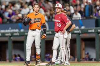 OSU's Aidan Meola (2) stands at first base next to OU's Dayton Tockey (16) during the Cowboys' 10-1 loss on Feb. 14 at Globe Life Field in Arlington, Texas.