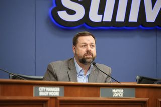 Stillwater Mayor Will Joyce seated at the council dais during the Feb. 19, 2026 city council meeting, with his nameplate visible in the foreground.