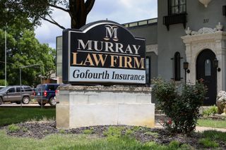 The existing Murray Law Firm and Gofourth Insurance monument sign at 311 S. Duck Street in Stillwater, where an LED panel is proposed to be added.