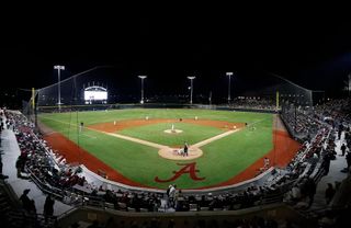 A wide view of Sewell-Thomas Stadium in Tuscaloosa, Ala., lit up for a night game. The venue hosts the 2026 Tuscaloosa NCAA Baseball Regional beginning May 29.