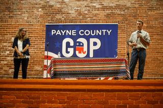 Payne County Commissioner Rhonda Markum and challenger Clayton Estus stand on stage at the Payne County GOP candidate forum on June 11, 2026, at the Stillwater Community Center in Stillwater.