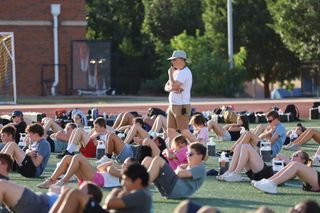 Director of Bands Kevin Zamborsky oversees Pioneer Marching Band members during physical training on the first day of Band Camp, July 27, 2026, at Pioneer Stadium in Stillwater.