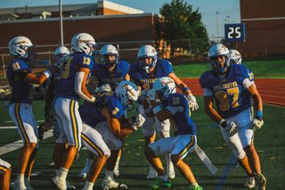 Stillwater senior Dian Fix (16) celebrates with teammates after his interception return for a touchdown against Fayetteville on Aug. 28, 2026, at Pioneer Stadium in Stillwater.