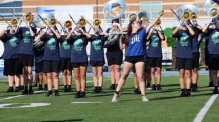 Stillwater color guard member Cammy Booth performs in front of the Pioneer Marching Band at the Deer Creek Marching Invitational on Saturday, Sept. 19, 2026, in Edmond.