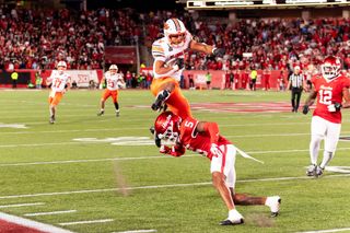 OSU running back Caleb Hawkins hurdles Houston defensive back Will James for a first down during OSU’s 35-32 loss on Oct. 17, 2026, at TDECU Stadium in Houston.