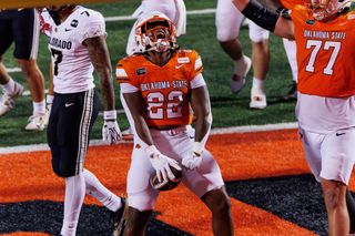 OSU running back William Mason celebrates in the end zone after a touchdown run against Colorado on Oct. 24, 2026, at Boone Pickens Stadium as lineman Ashton Lepo raises his arms.
