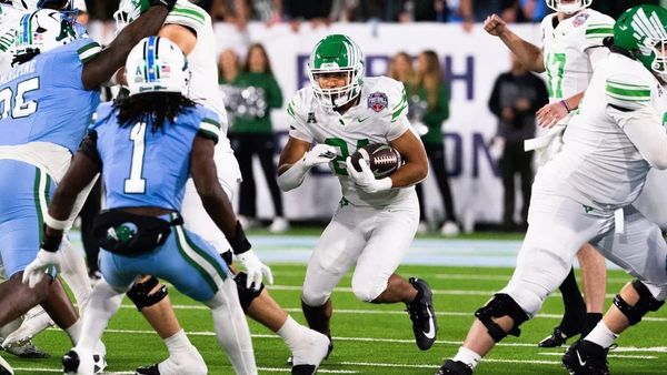 North Texas running back Caleb Hawkins carries football against Tulane defenders during American Athletic Conference Championship Game in New Orleans on Dec. 5, 2025.