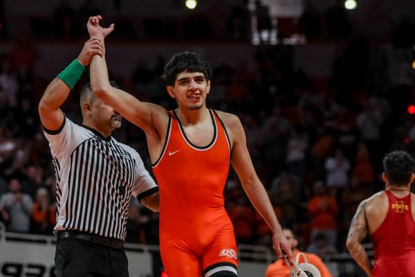 Oklahoma State's Sergio Vega has his hand raised after defeating Iowa State's Anthony Echemendia 4-2 at 141 pounds during OSU's 24-9 win over the Cyclones Sunday at Gallagher-Iba Arena.