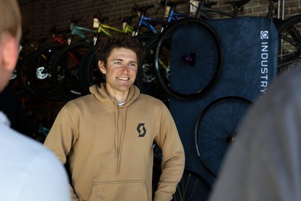 Cameron Jones at a pre-race meet-and-greet at District Bicycles in Stillwater, Oklahoma, March 12, 2026, wearing a Scott Cycling hoodie.