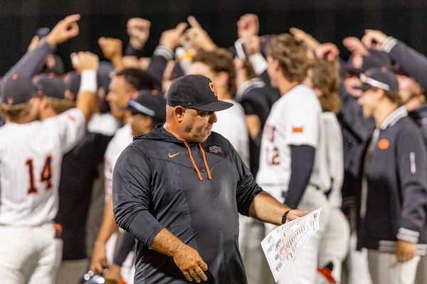 OSU head coach Josh Holliday walks among celebrating players after his 500th career win, a 14-4 run-rule victory over Wichita State at O'Brate Stadium in Stillwater on April 21, 2026.