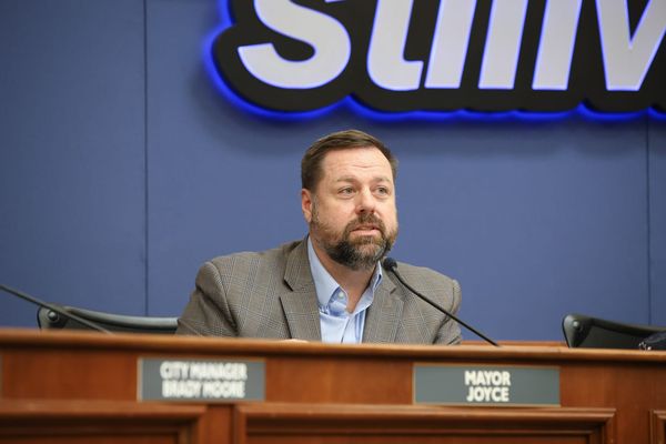 Stillwater Mayor Will Joyce seated at the council dais during the Feb. 19, 2026 city council meeting, with his nameplate visible in the foreground.
