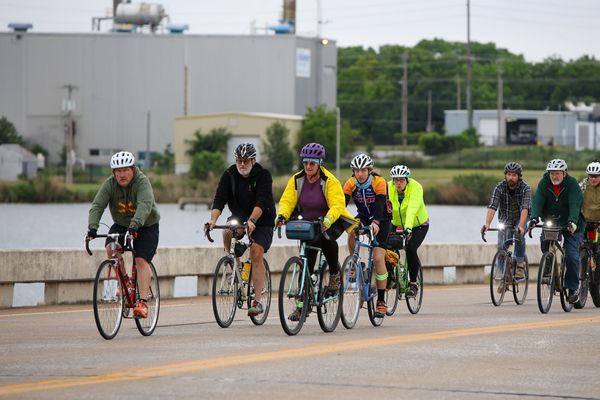 A group of cyclists crosses the Lakeview Road bridge over Boomer Lake during Stillwater's Ride of Silence on May 20, 2026.