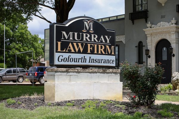 The existing Murray Law Firm and Gofourth Insurance monument sign at 311 S. Duck Street in Stillwater, where an LED panel is proposed to be added.
