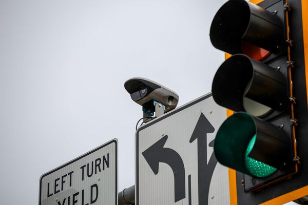 A NoTraffic video detection camera mounted on a traffic signal mast at Washington Street and Hall of Fame Avenue in Stillwater, with a green light and left turn yield sign visible.