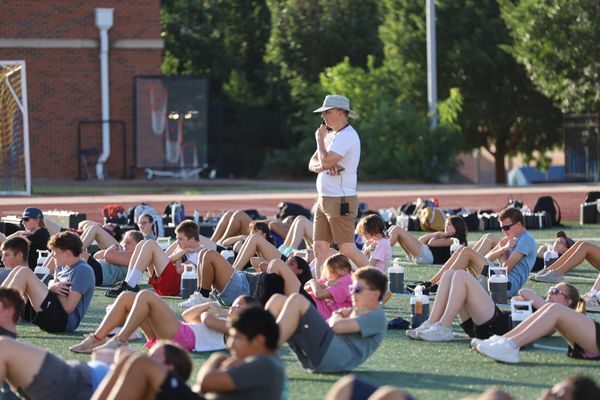 Director of Bands Kevin Zamborsky oversees Pioneer Marching Band members during physical training on the first day of Band Camp, July 27, 2026, at Pioneer Stadium in Stillwater.