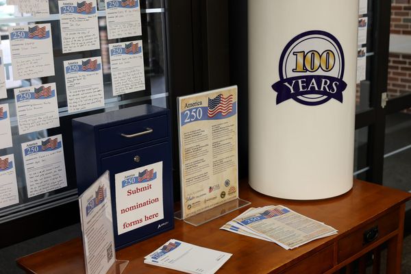 A display near the Stillwater Public Library's southwest entrance holds America 250 nomination narratives, a ballot box and the time capsule that will store the winning books.