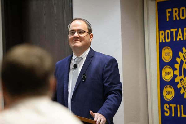 District Attorney Jeremiah Gregory speaks at a podium beside a Stillwater Frontier Rotary Club banner on Thursday, Aug. 6, 2026, in Stillwater.