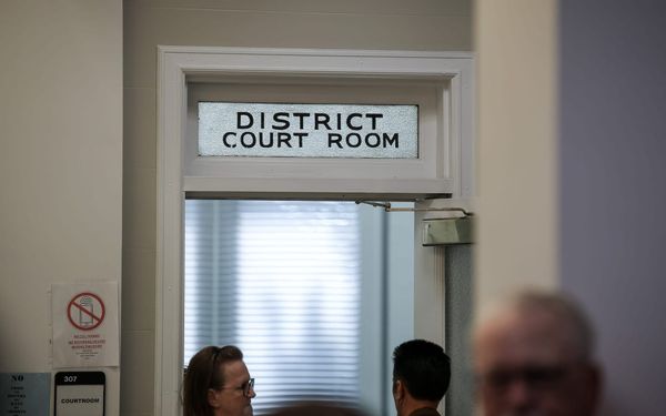 The entrance to Courtroom 307, the district courtroom on the third floor of the Payne County Courthouse in Stillwater. A frosted-glass transom reads "District Court Room."