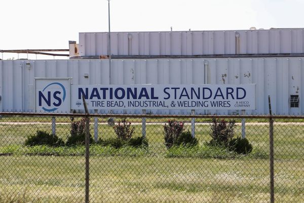 A sign reading "National Standard: Tire Bead, Industrial, and Welding Wires, A Heico Company," outside the company's Stillwater manufacturing plant.