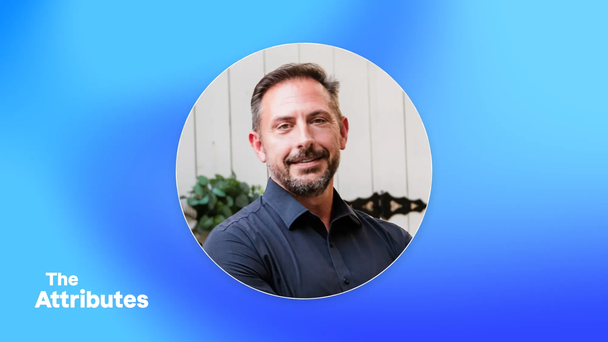 Headshot of a smiling bearded man in a navy button-down shirt on a blue gradient background with text The Attributes