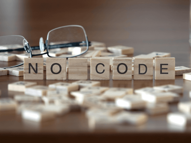 Words No Code in Scrabble blocks on table.