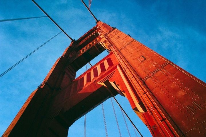 Large red-orange bridge with viewpoint aimed at the sky.
