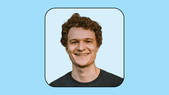 A headshot of Peter Kwitny on a light blue background.