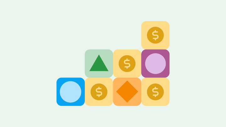 Building blocks with shapes in the center. Several, including the highest, have dollar signs.