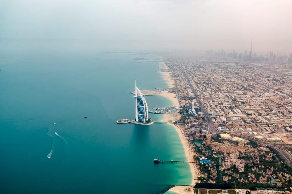 aerial photo of Dubai coastline with hazy sky background and burj al arab