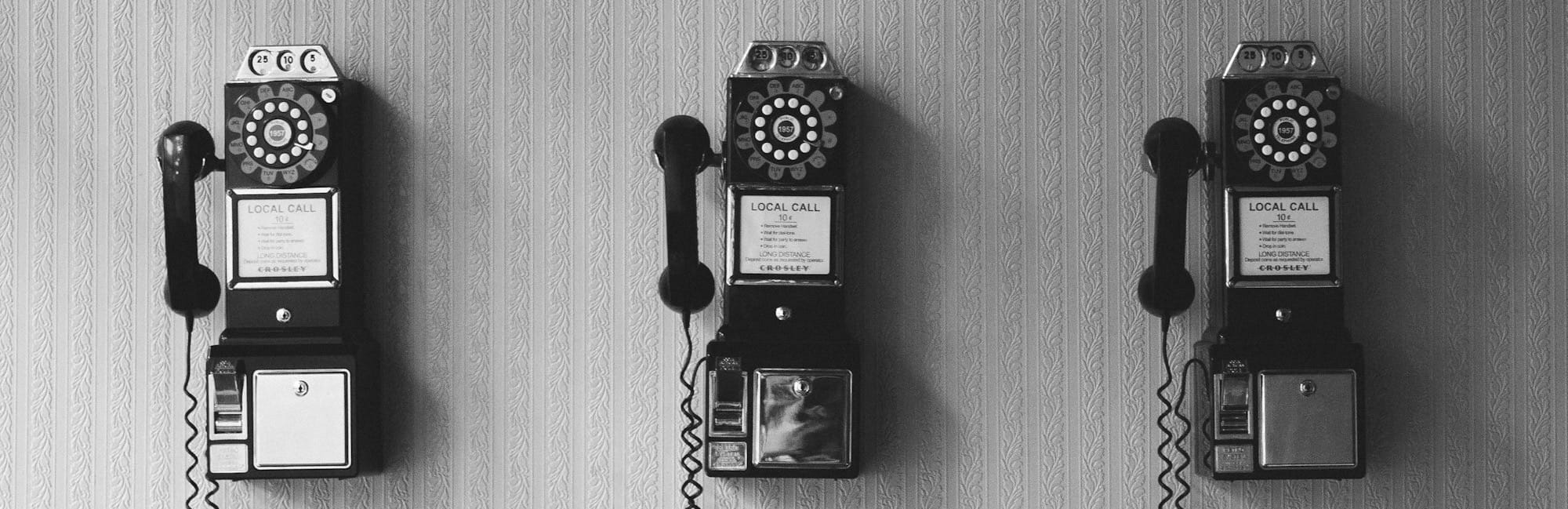 minimalist photography of three crank phones