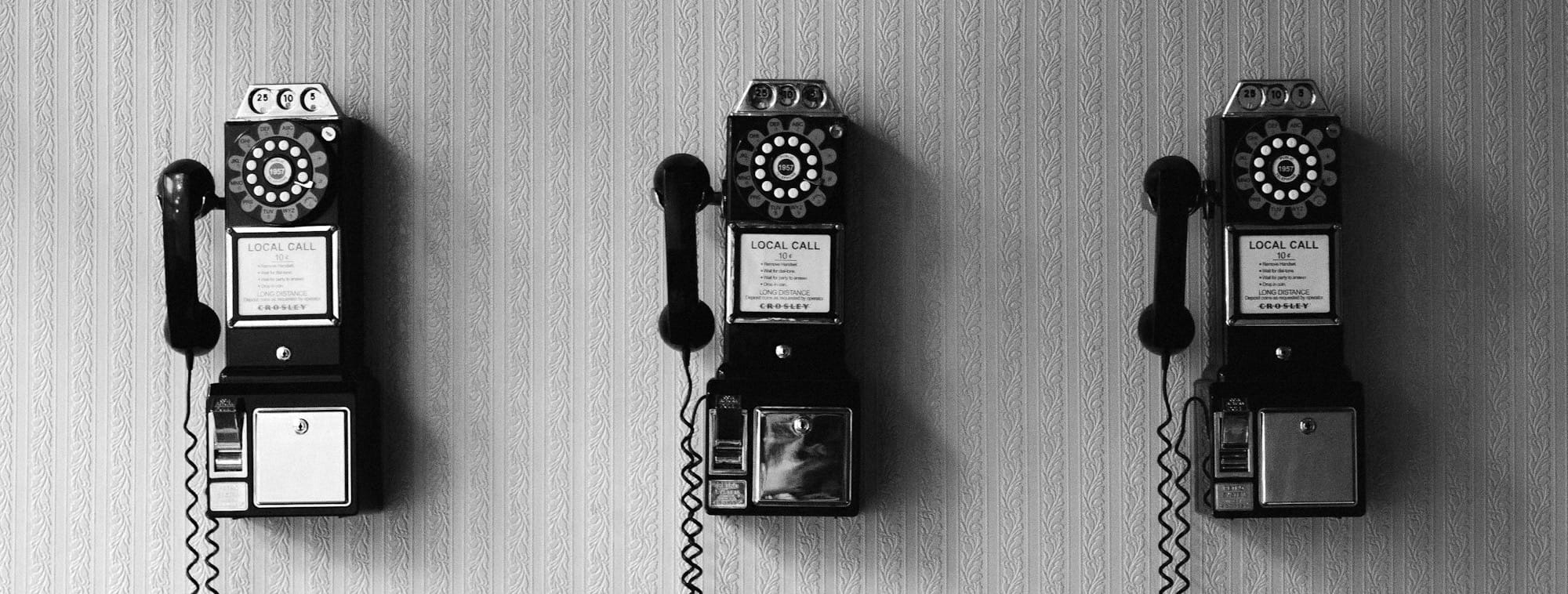 minimalist photography of three crank phones