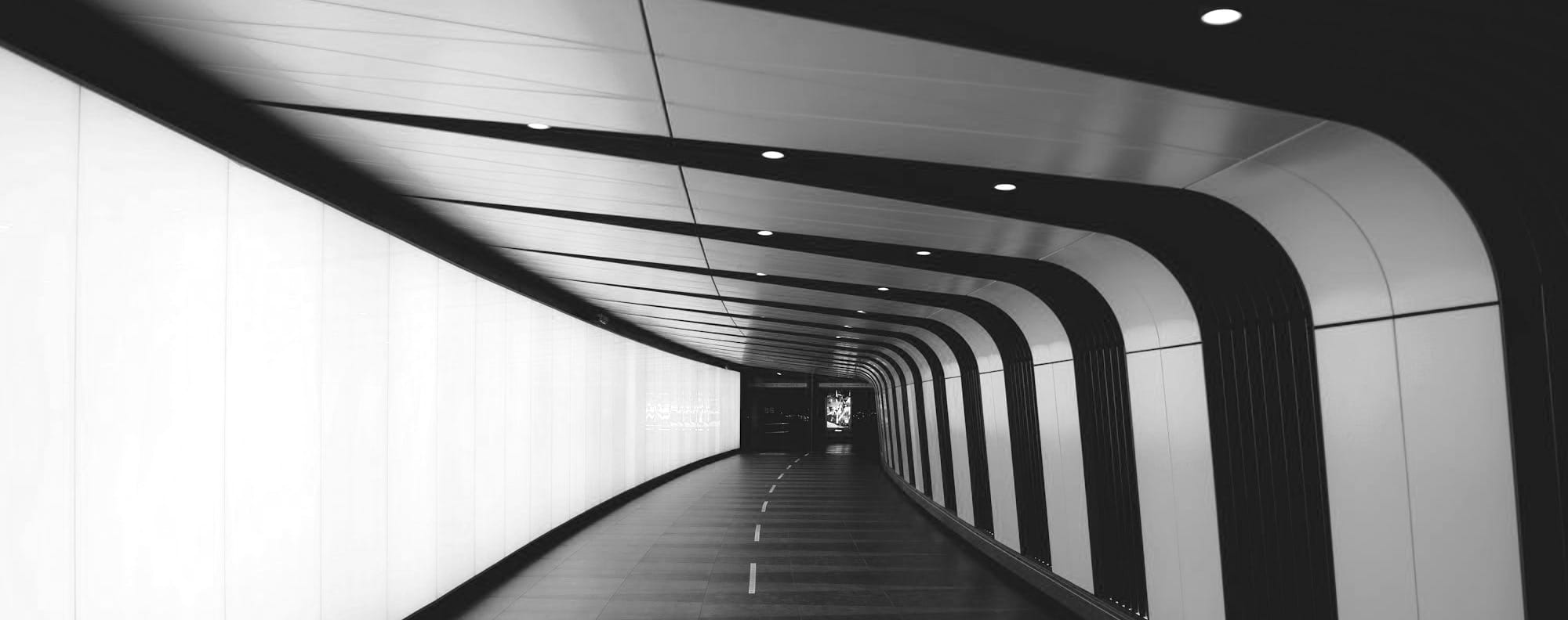 a very long tunnel with a light at the end